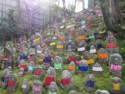 Dozens of Jizo with colorful bibs
